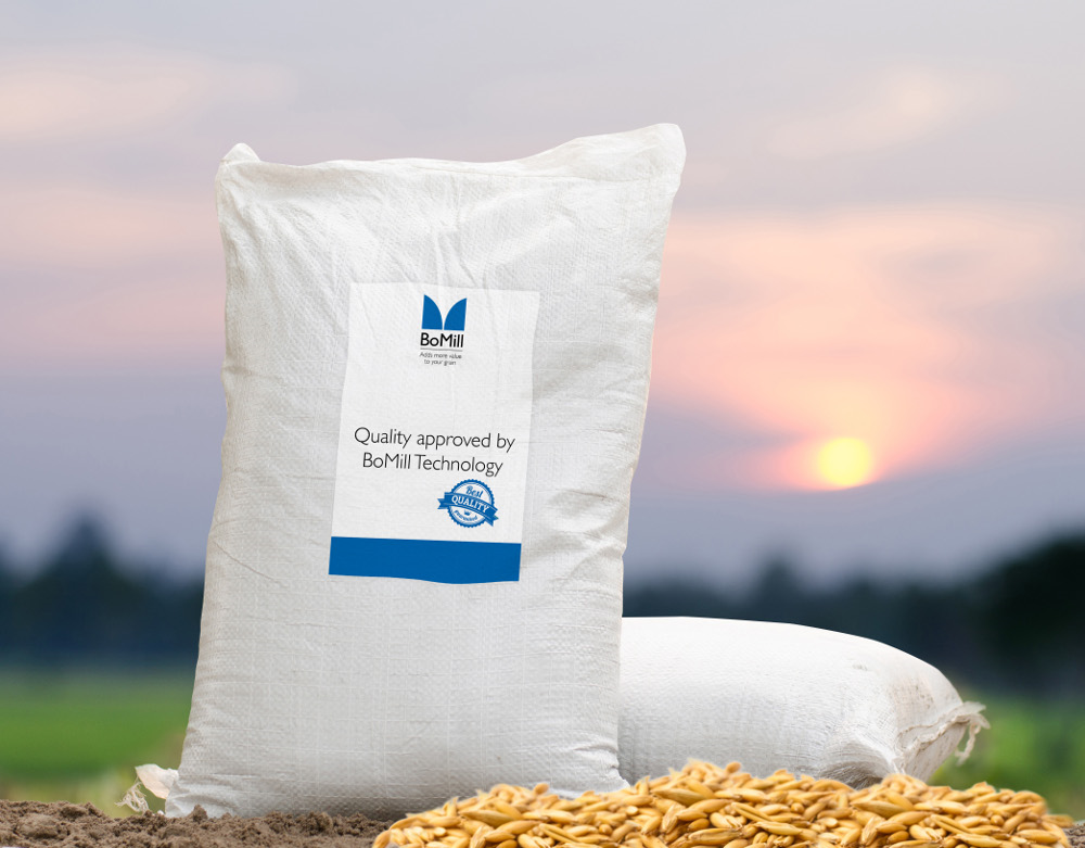 Image of BoMill oat grains in a bag in front of a sunset.