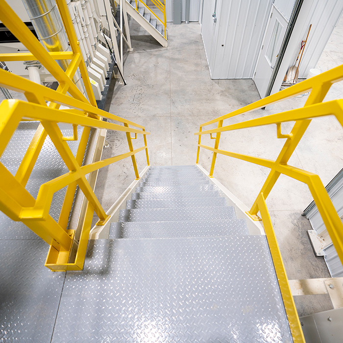 Image of equipment platform and stairs in a seed conditioning facility